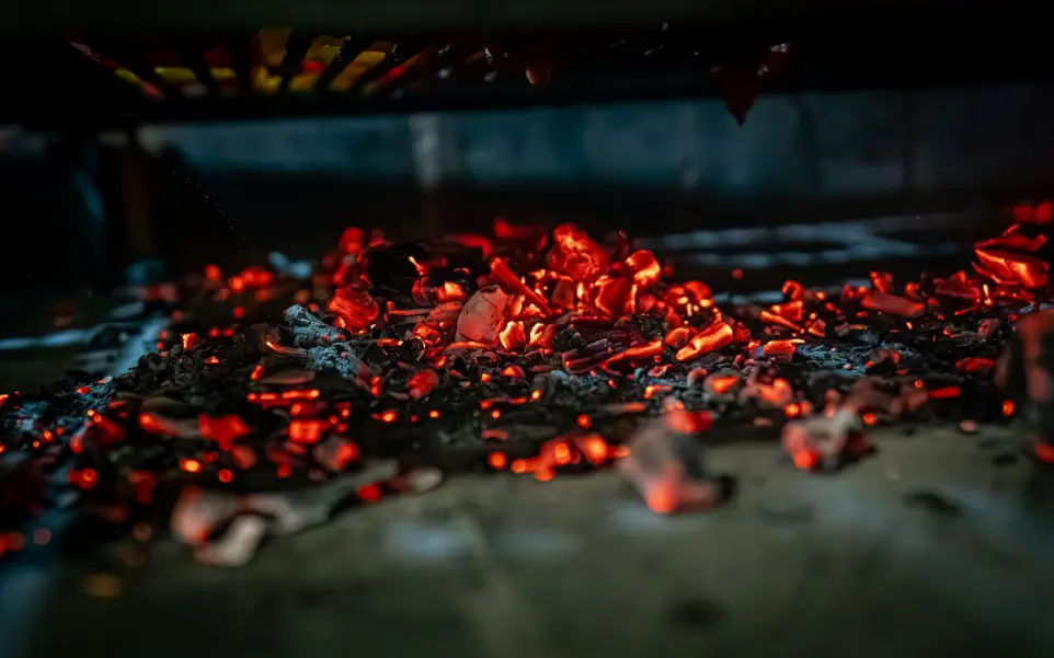 a pile of red hot coals sitting on top of a table